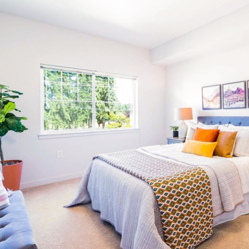 a bedroom with a bed and lamps