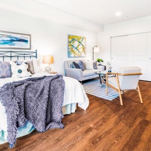 a bedroom with a bed and a chair