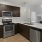 a kitchen with black cabinets