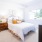a bedroom with a bed and a plant